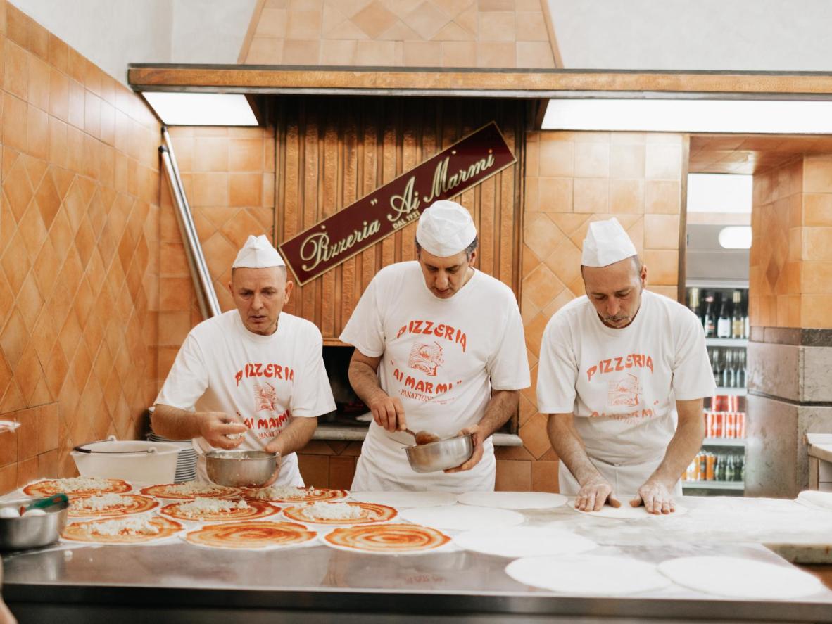 Grab a delicious slice of artfully handmade pizza at Ai Marmi