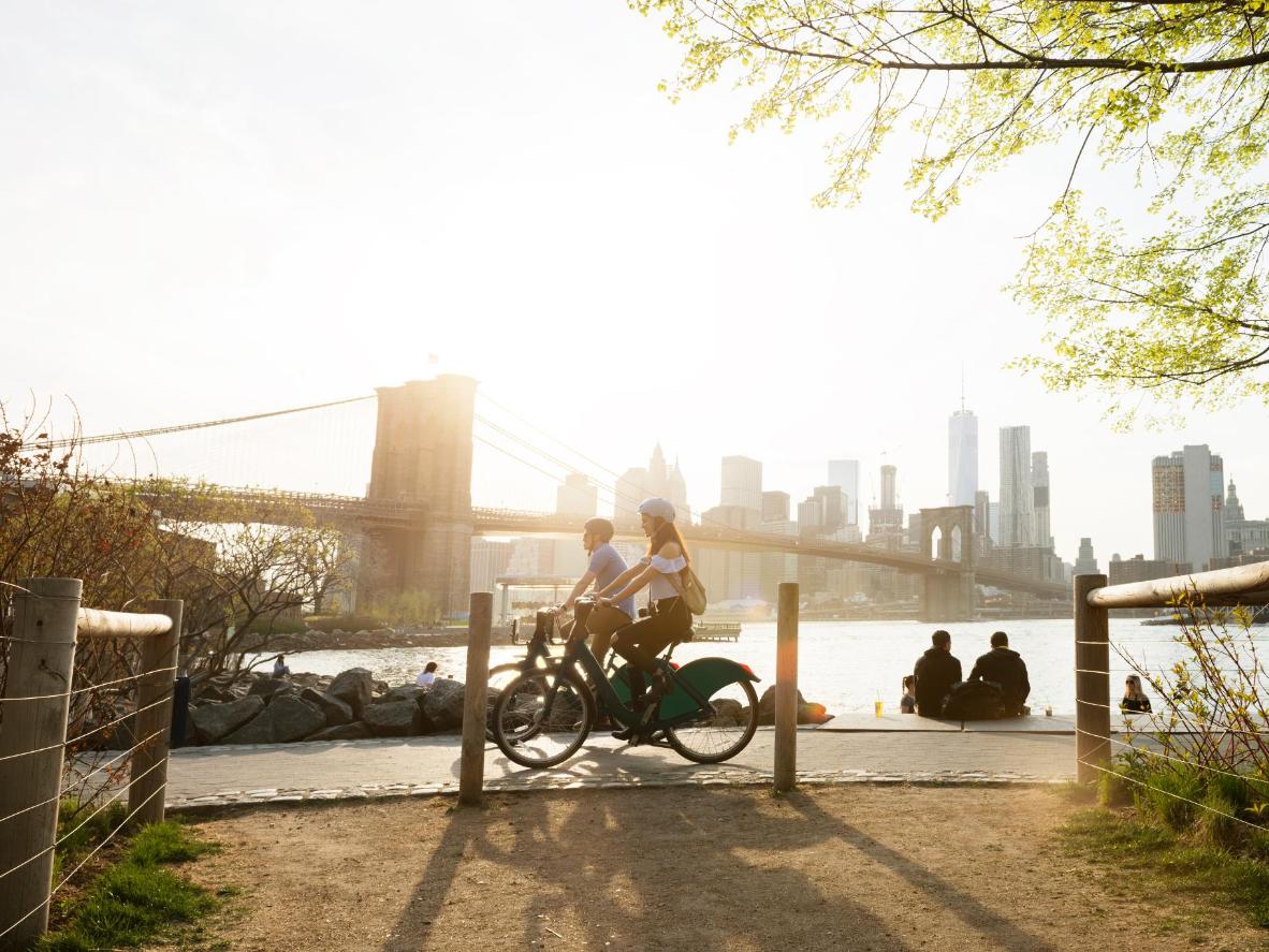 Bike through New York City, passing sights like the Brooklyn Bridge