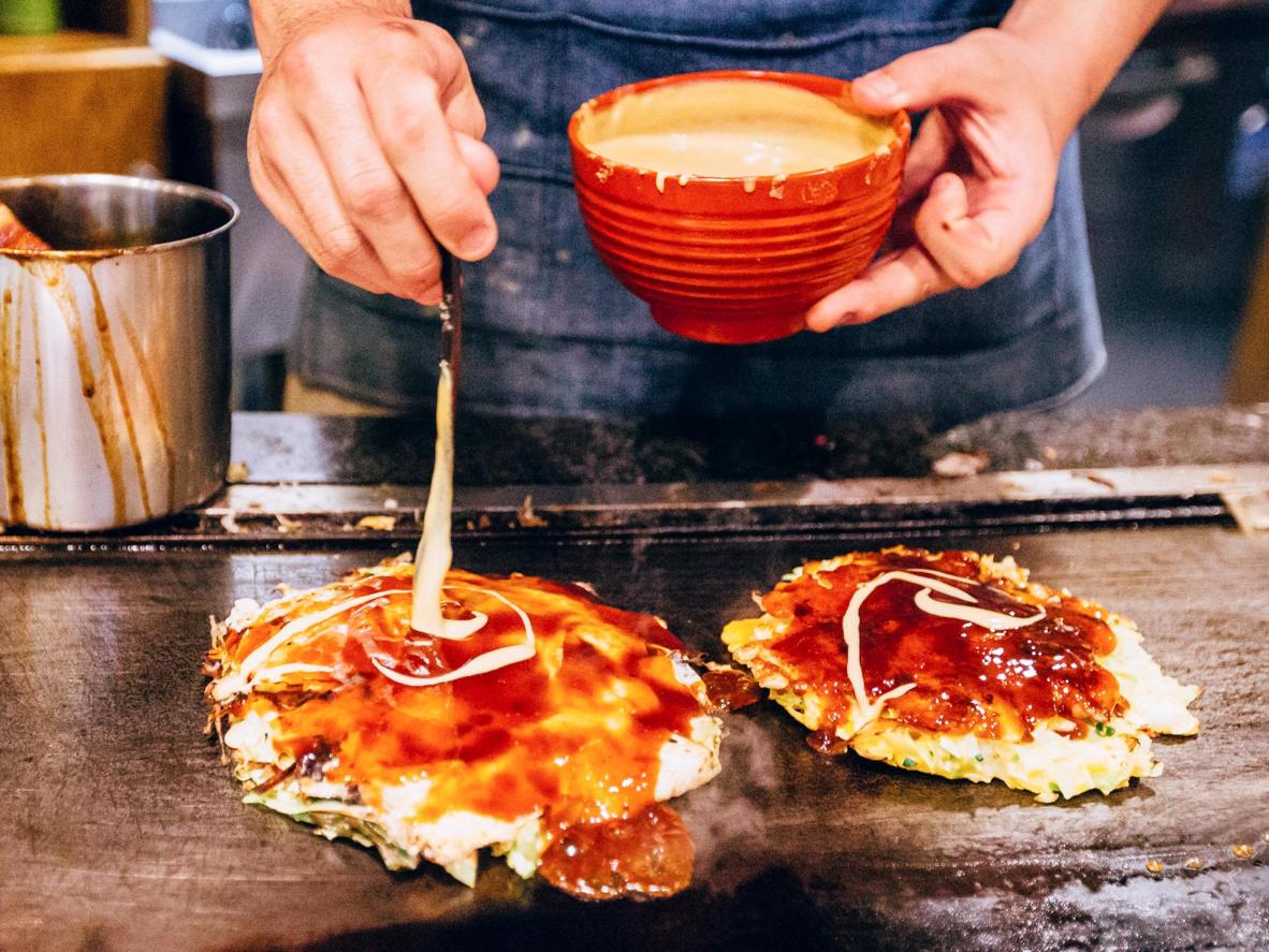 In addition to cherry blossoms, foodies must visit Osaka to try the city's signature dish, okonomiyaki