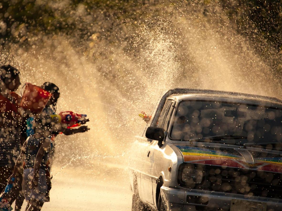 People use plastic water guns to splash others during the Songkran festival