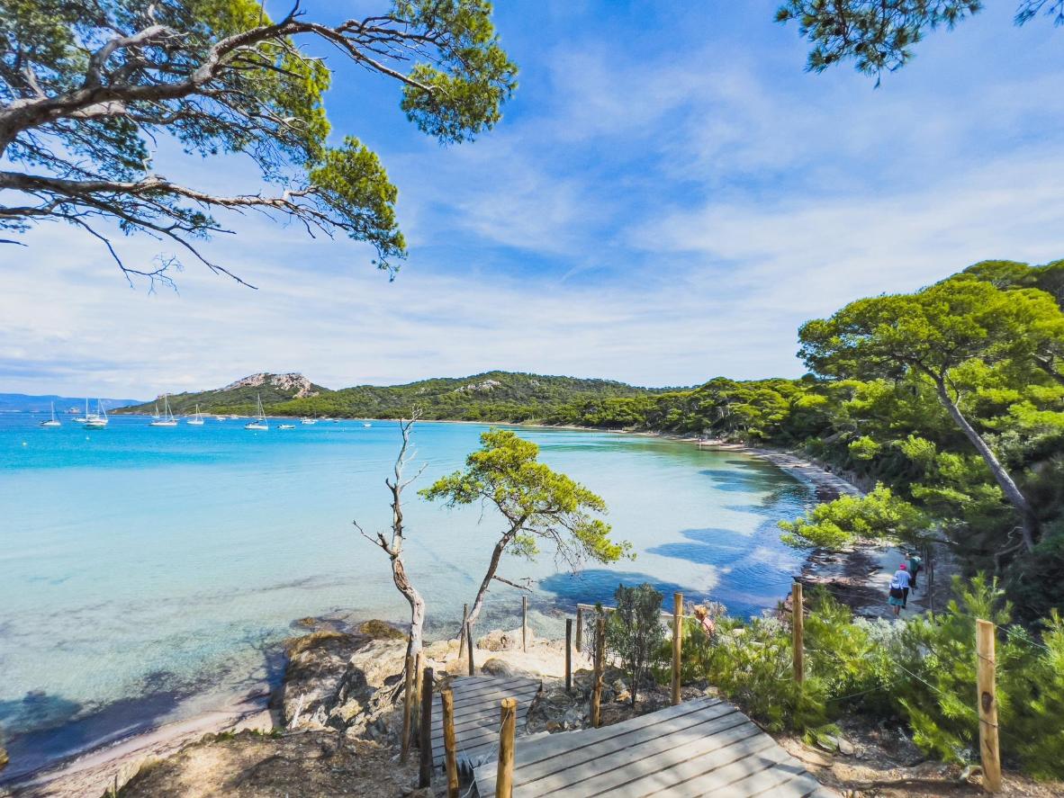 Discover the untouched beauty of Plage de Notre-Dame on Île de Porquerolles. A tranquil oasis where turquoise waters meet pristine white sands, it's a paradise for families seeking serenity and adventure.