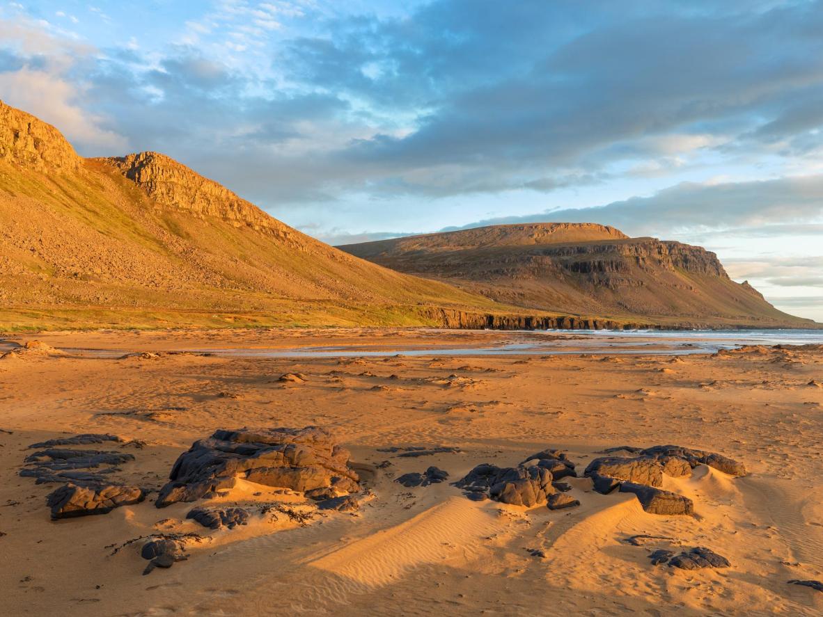 Enjoy a beautiful sunset over Raudisandur Beach in Iceland's southern Westfjords