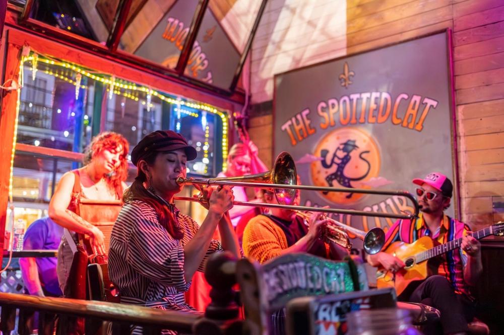 Some musicians playing at The Spotted Cat, a lively jazz club known for its vibrant atmosphere and live music performances