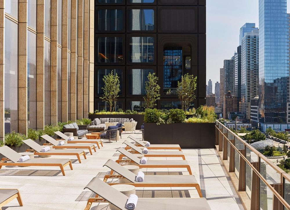 Rooftop deck of the Equinox Hotel featuring Electric Lemon, showcasing city views and stylish outdoor seating