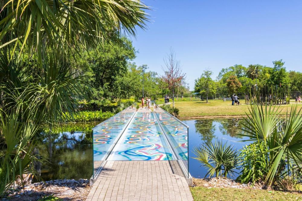 A vibrant bridge adorned with colourful designs, located in City Park, enhancing the park's lively atmosphere