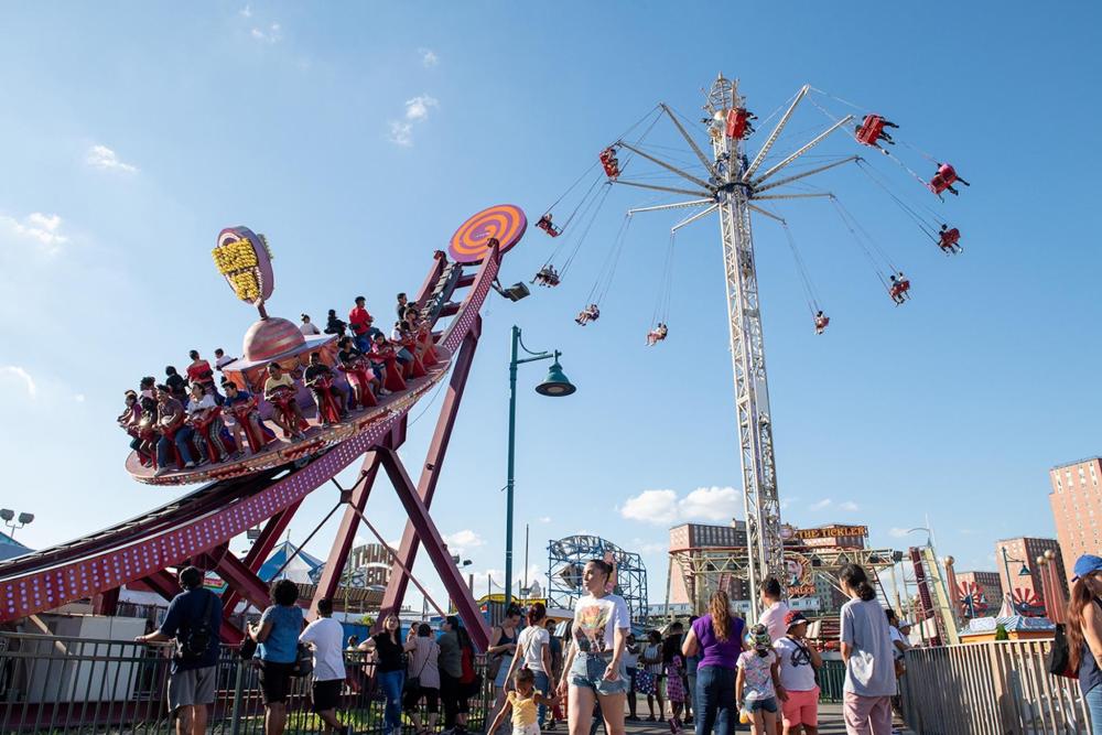 A large amusement ride at Coney Island, towering over the vibrant attractions and excited visitors below