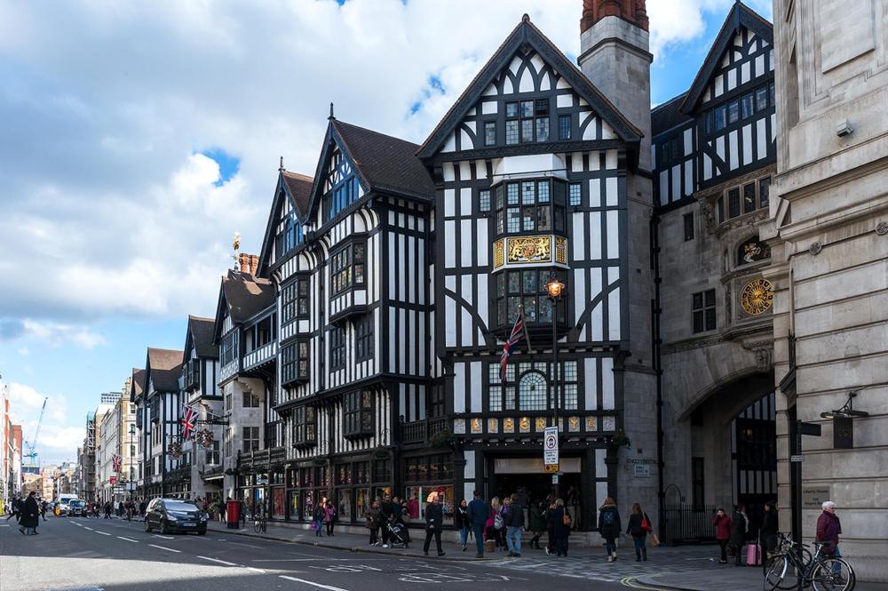 A large historic white building with black beams features a prominent architectural design in London's urban setting.