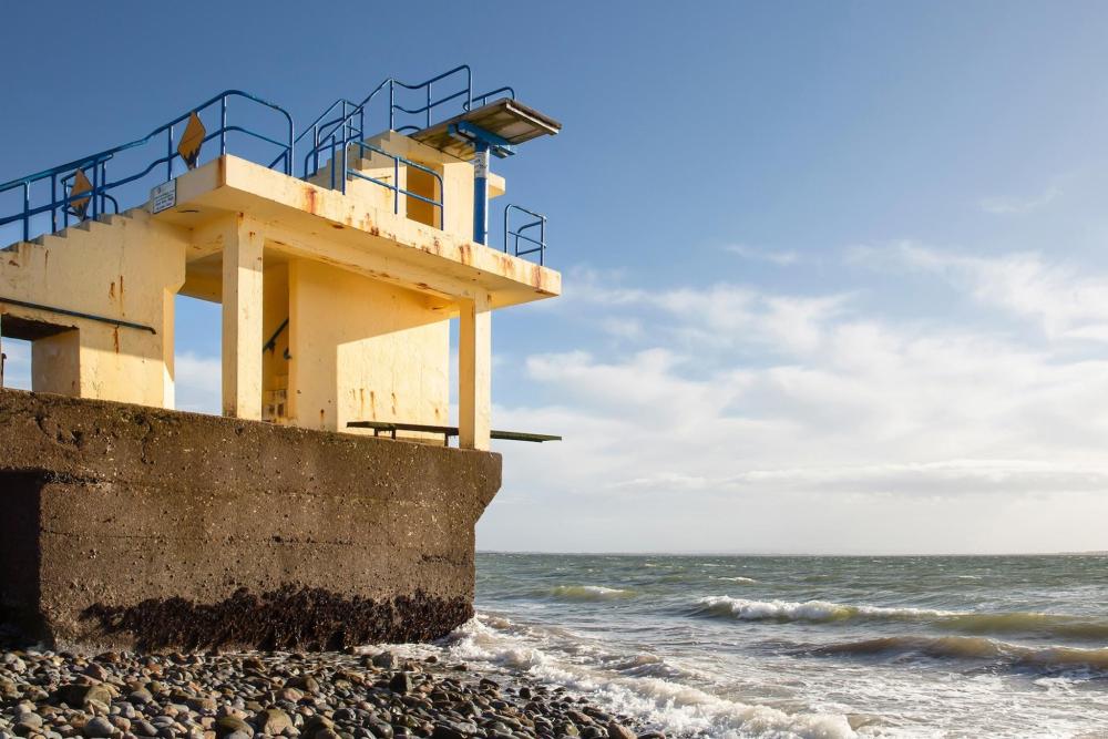 A scenic view of a rocky shore in Galway, showcasing rugged cliffs and the gentle waves