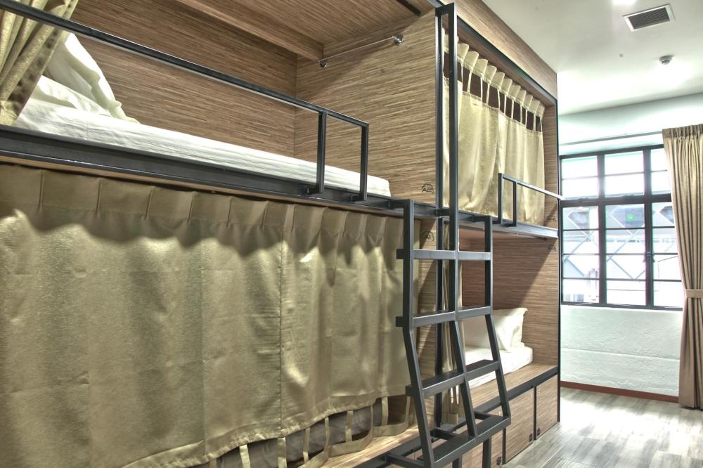 Beige curtains cover the pods in a capsule hotel room in Singapore’s Dream Lodge.