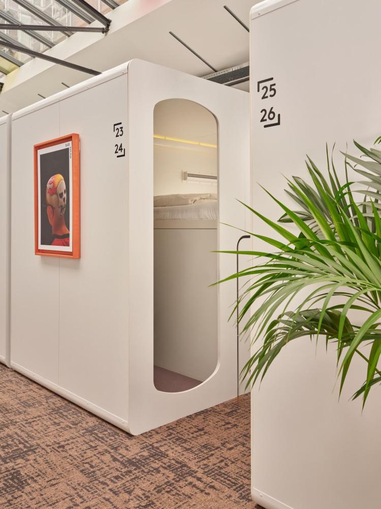 A white capsule pod at CityHub Amsterdam is bright and airy.