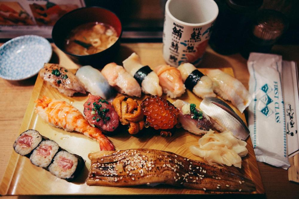 A board of sushi is featured looking both vibrant and delicious