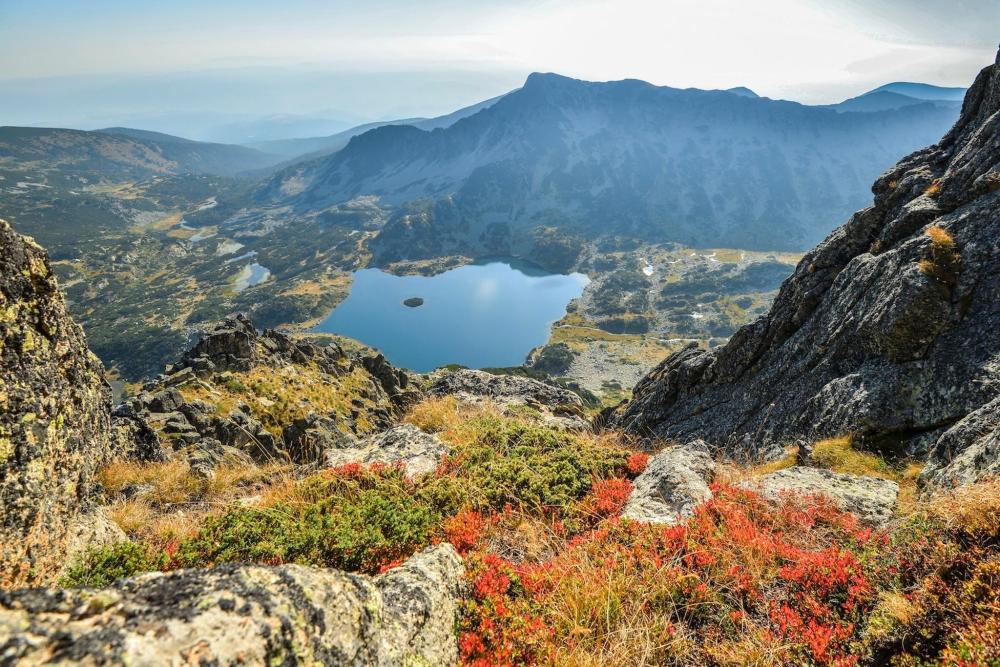 The mountains of Bankso with a body of water in the centre and shrubbery around