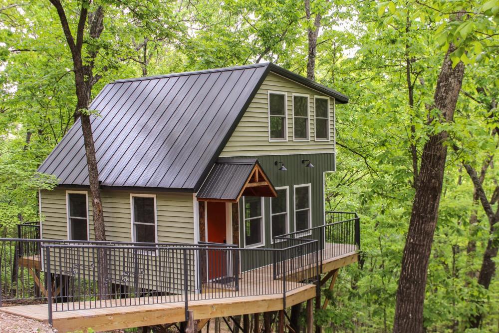 Tree Hugger Hideaway in Missouri features a cozy tree house surrounded by lush woodland scenery.