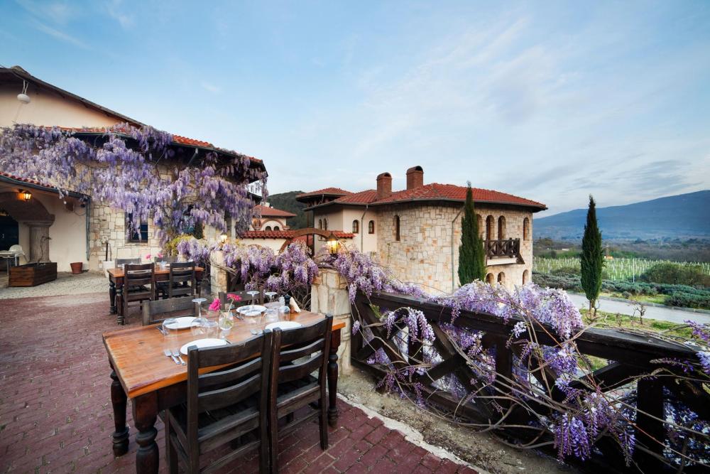 A charming patio scene at Vinifera Vineyards Hotel in Turkey, complete with a table and chairs for outdoor relaxation.