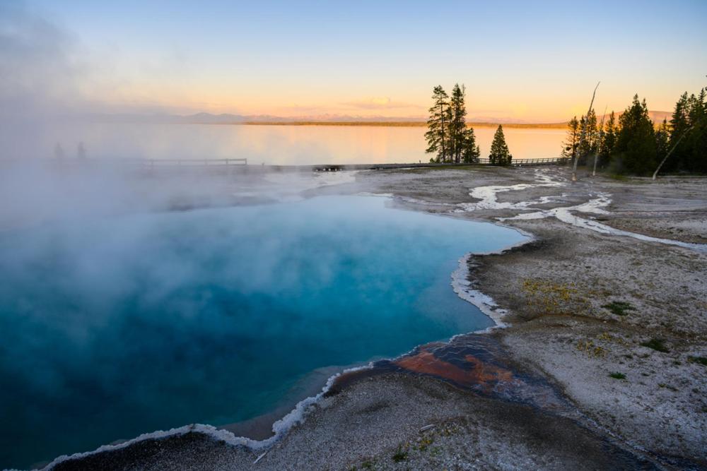 A picturesque scene of Yellowstone Lake, highlighting its large body of water amidst the stunning backdrop of Wyoming's wilderness.