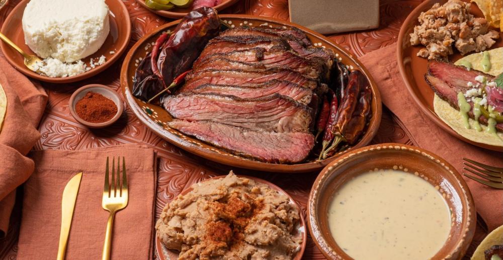 A plate of brisket topped with colourful peppers, showcasing a delicious and hearty meal