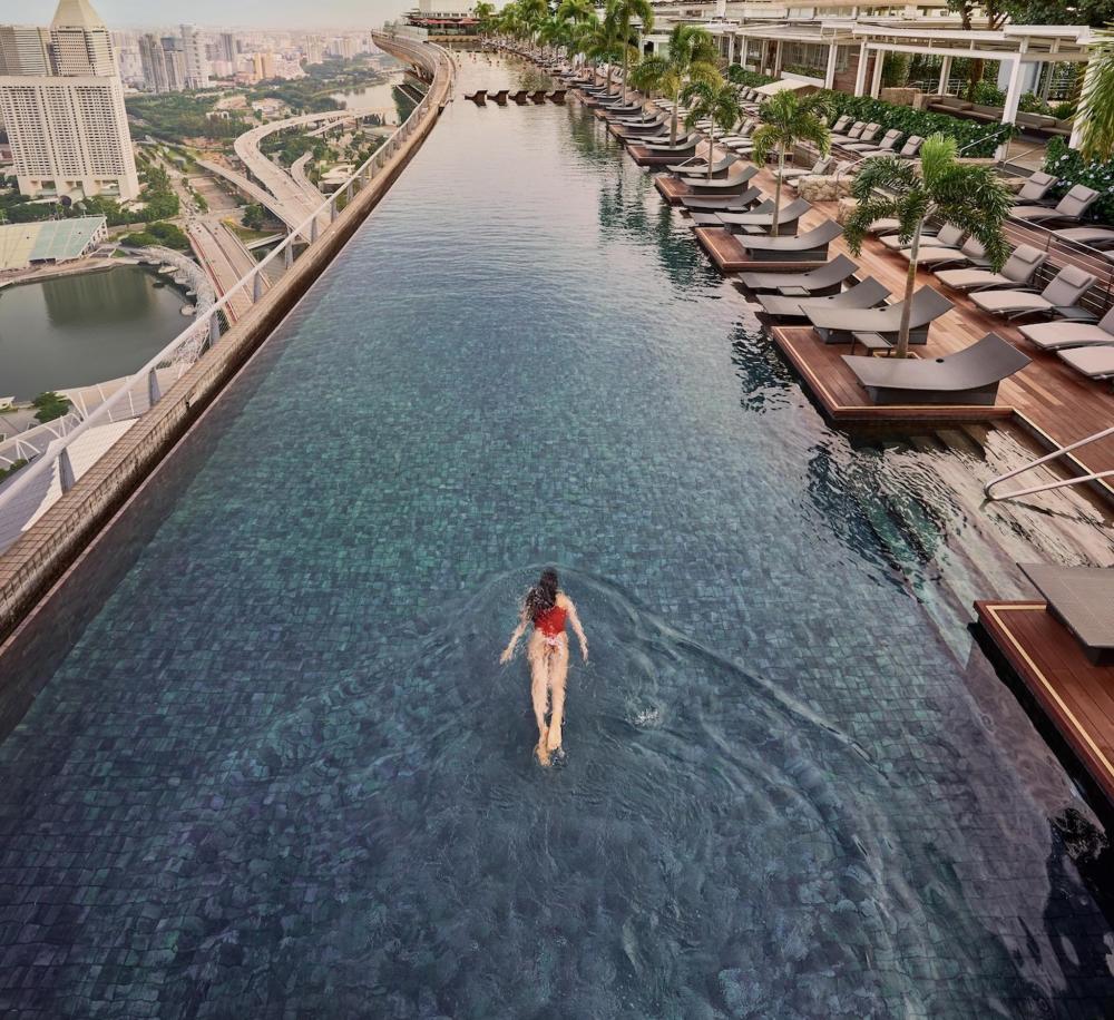 A woman swims in the pool at Marina Bay Sands, Singapore, enjoying the stunning skyline view