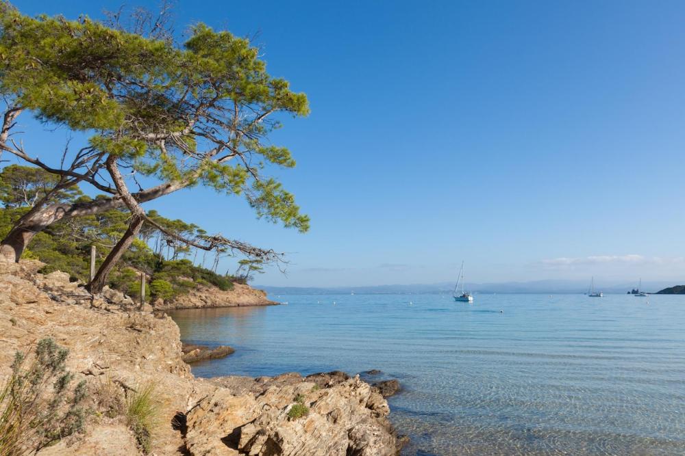 Bright blue sky above a rocky beach Porquerolles, reflecting a peaceful and sunny day