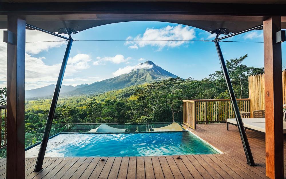 Scenic view of mountains from the pool and decking of Nayara Tented Camp, showcasing nature's beauty
