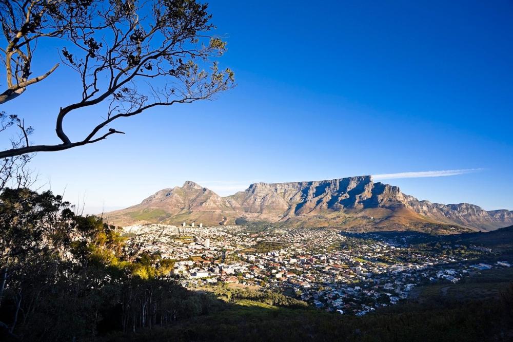 A panoramic view of Table Mountain in Cape Town, South Africa, showcasing its iconic flat-topped silhouette against the sky