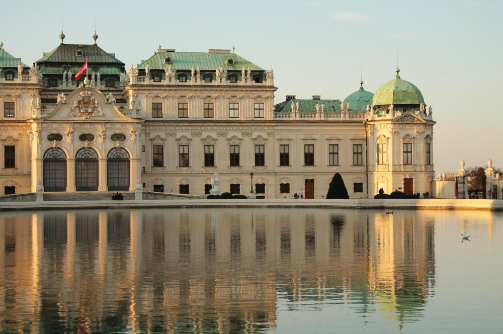 Belvedere Palace is depicted with the lake reflecting its magnificent stature 