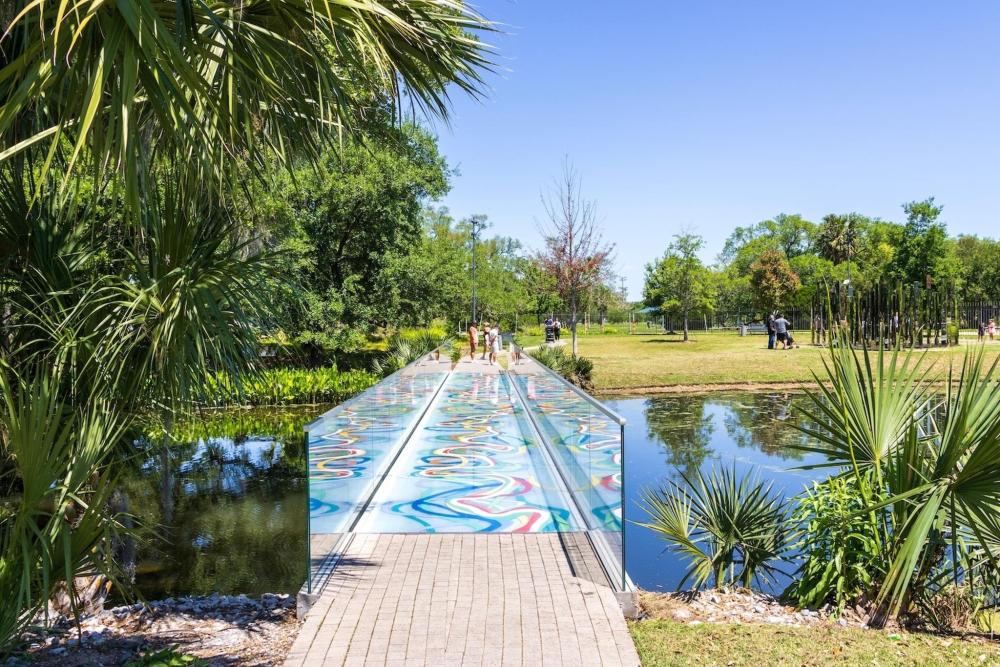A vibrant bridge adorned with colourful designs, located in City Park, enhancing the park's lively atmosphere