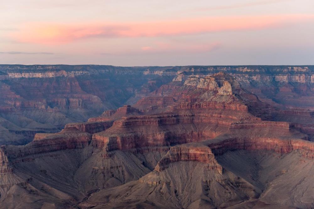The Grand Canyon illuminated by a sunset, showcasing rich colours and dramatic rock formations