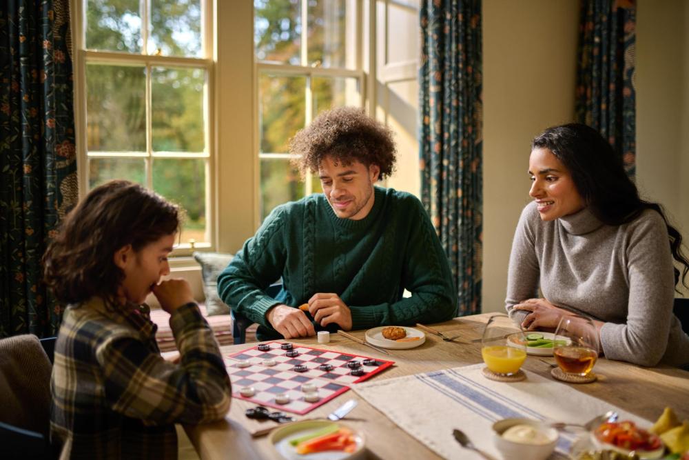 A family on holiday playing some games in their holiday home rental