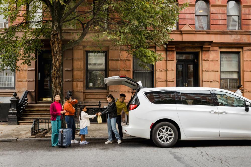 Family loading luggage into car