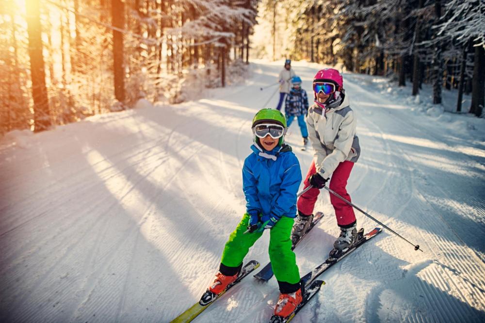Kids skiing on snowy trail