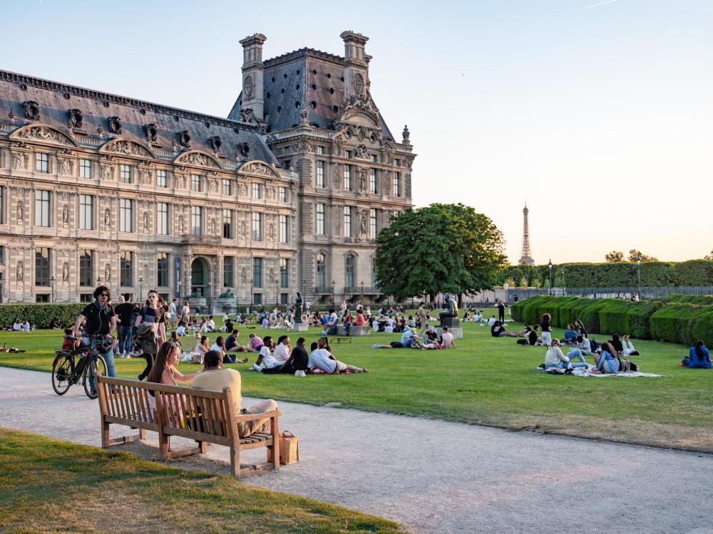 People relaxing and picnicking in a Paris park