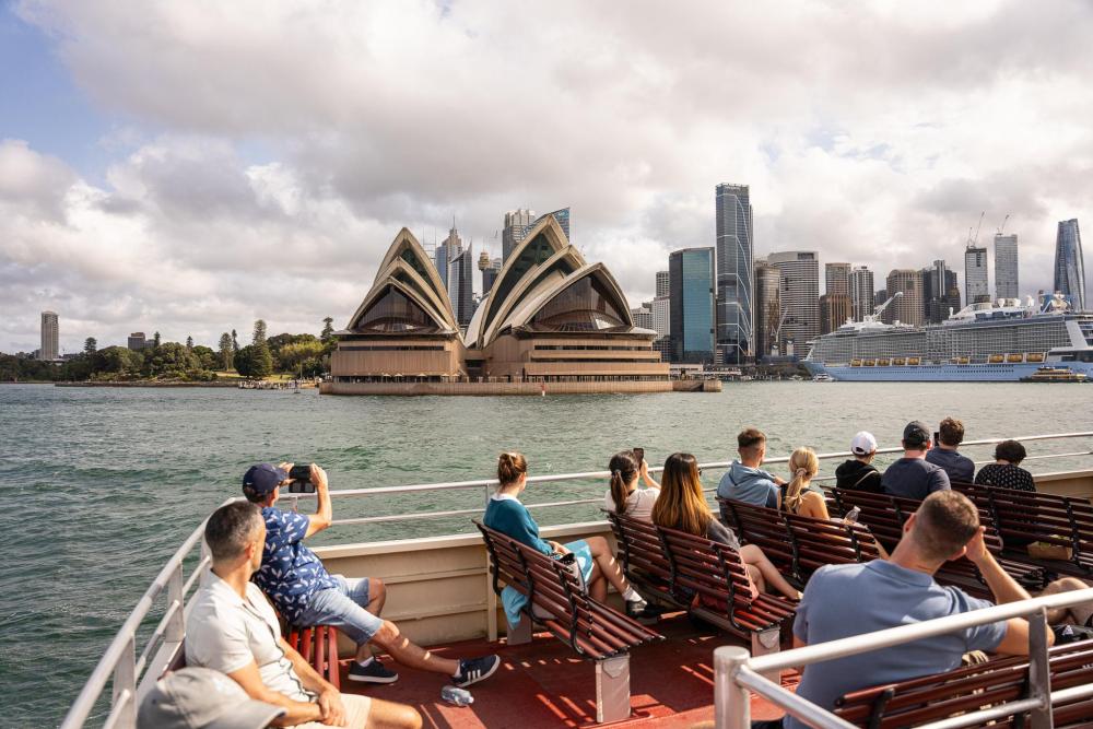 Visitors on ferry passing Sydney Opera House