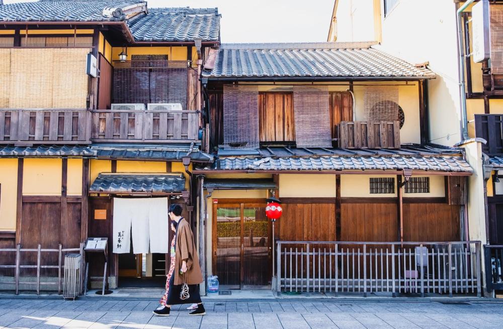 A couple of people stroll through the Gion district in traditional clothing