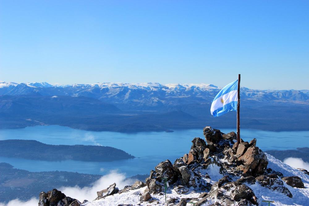 Argentine flag on a snowy mountain summit