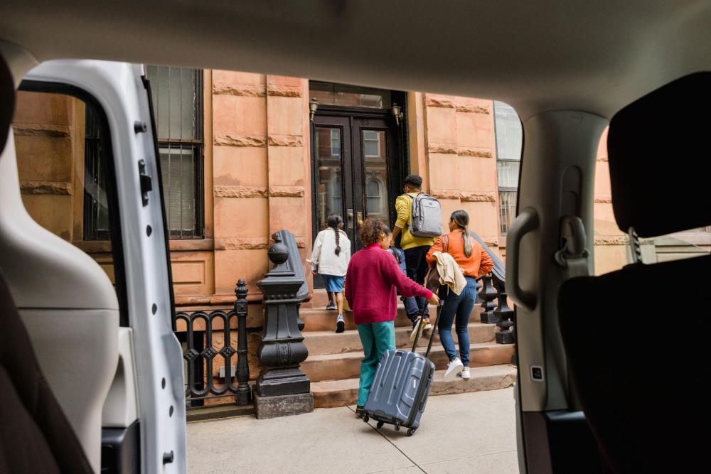 People with luggage approaching their accommodation