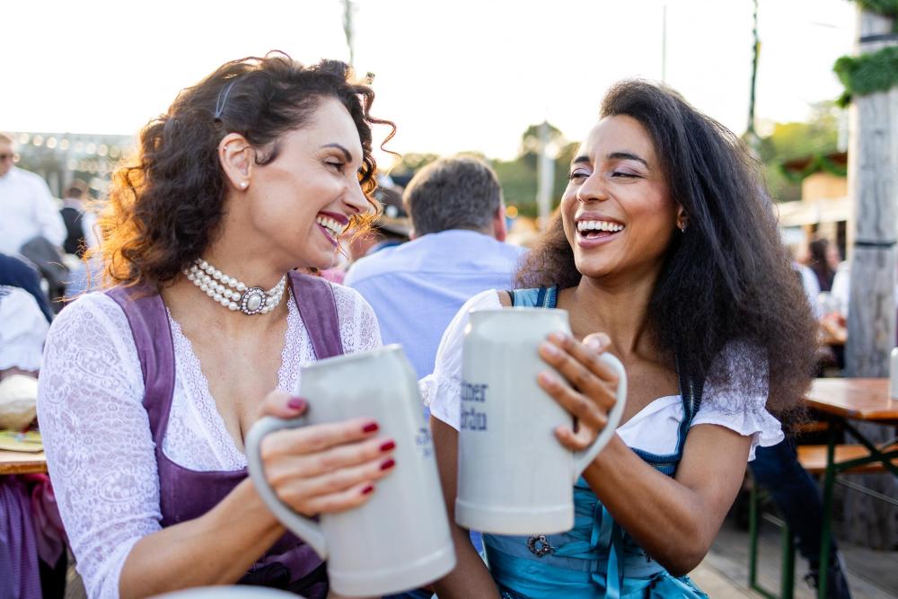 Women holding beer steins at Oktoberfest in Munich.