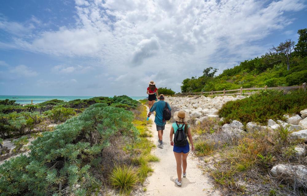Visitors walking along a coastal trail beside the sea in Bahia Honda State Park