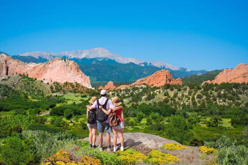 Family overlooking the red rock formations at Garden of the Gods.