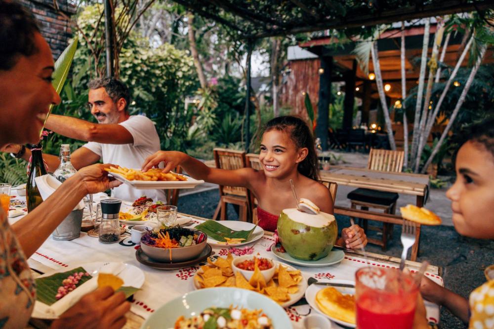 A family enjoying their meal in an outdoor setting