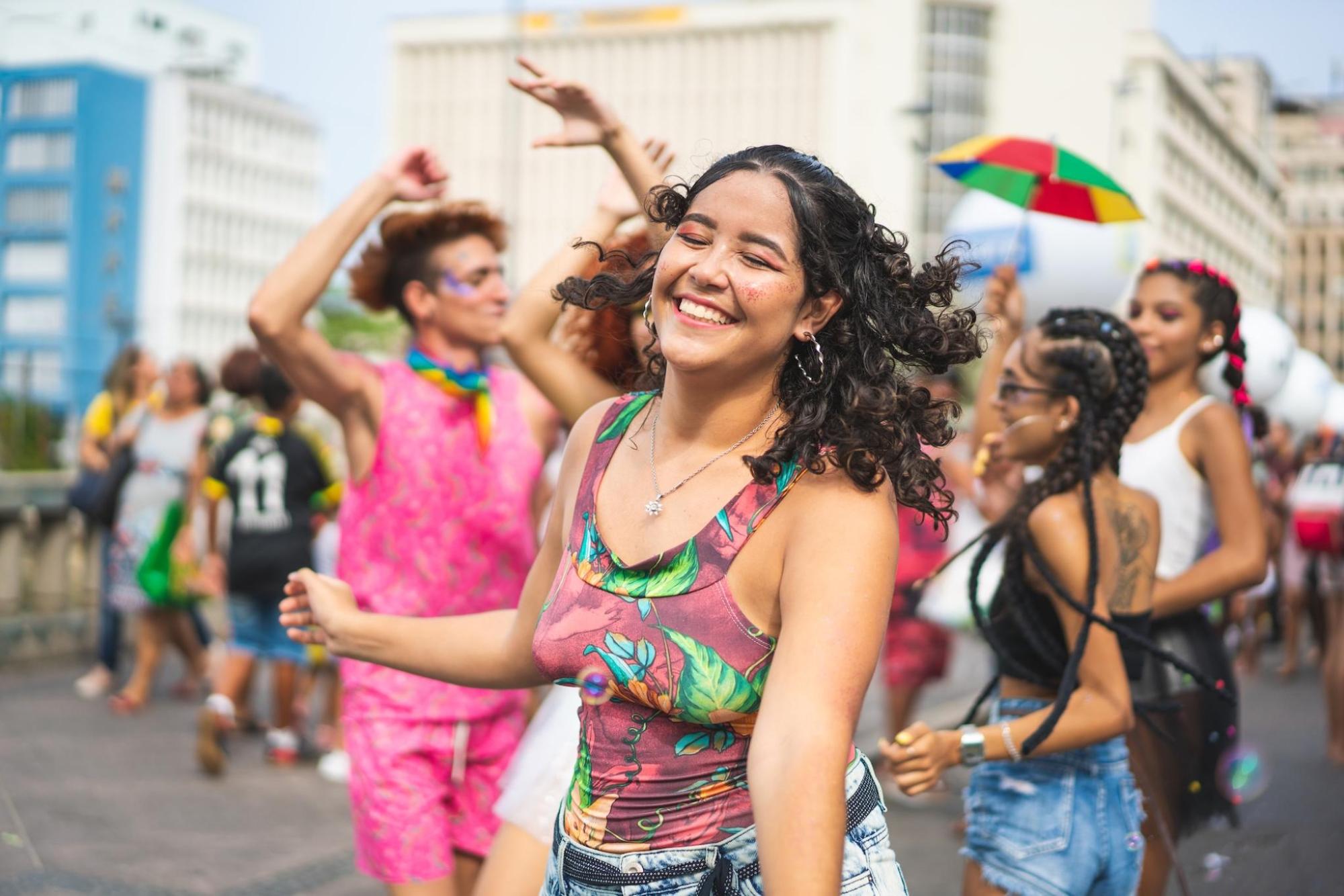 In Brazil, a woman dances energetically in the street