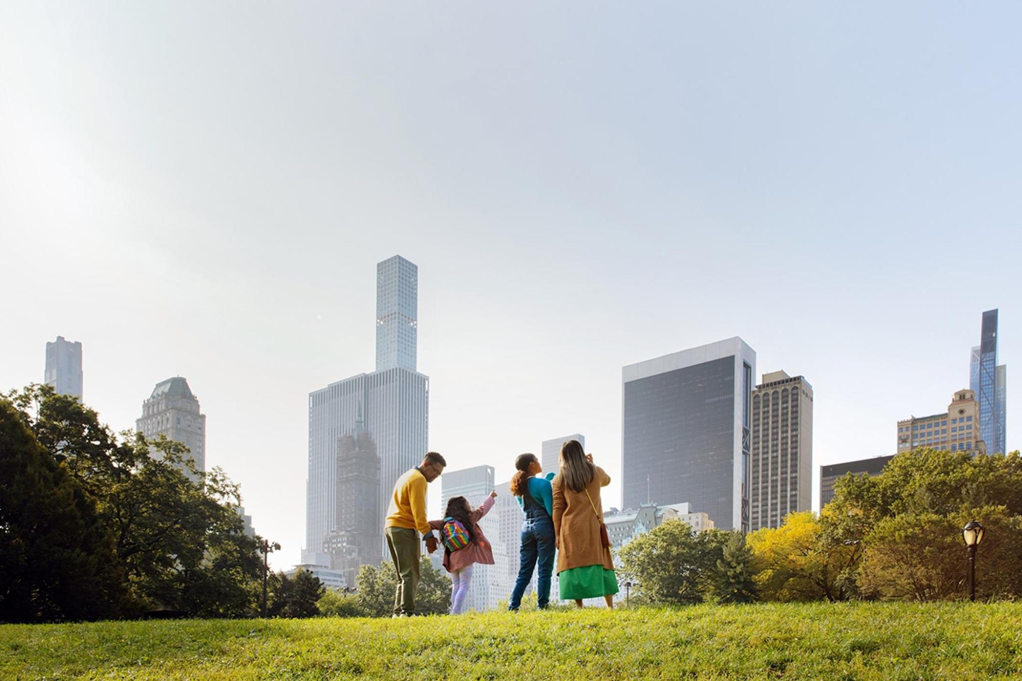 A family gathered in a park, admiring NYC's landscape