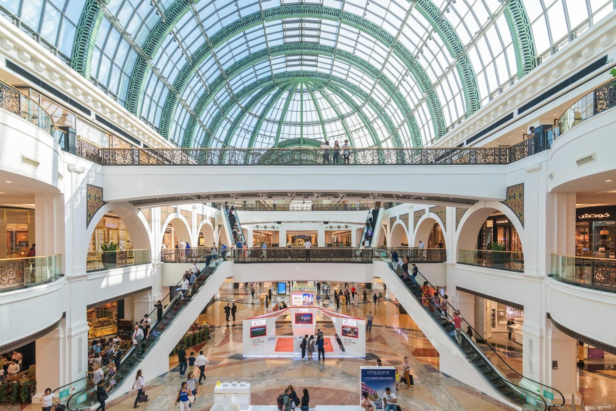 A shopping centre is visible with a domed roof