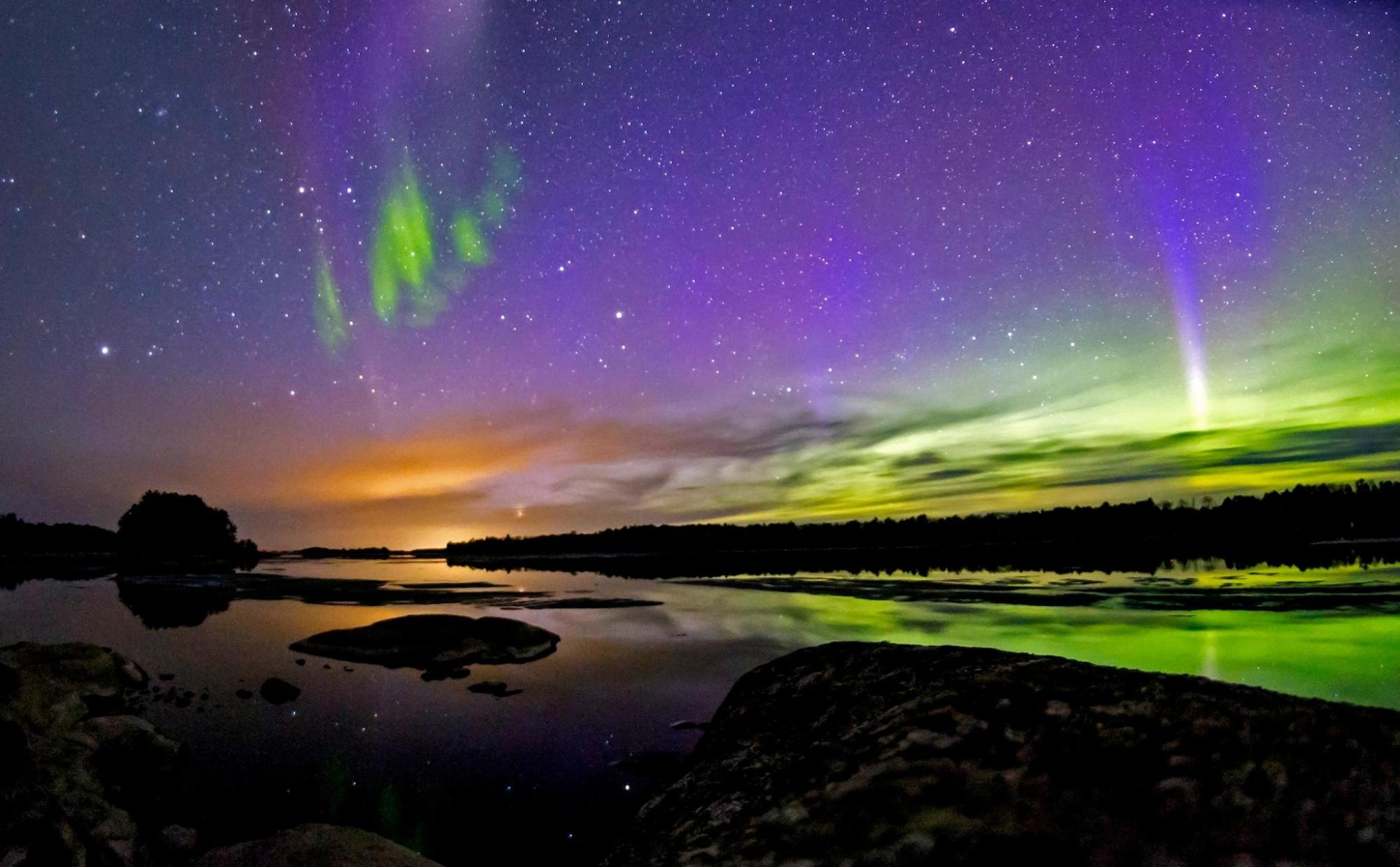 The northern lights dance across the sky