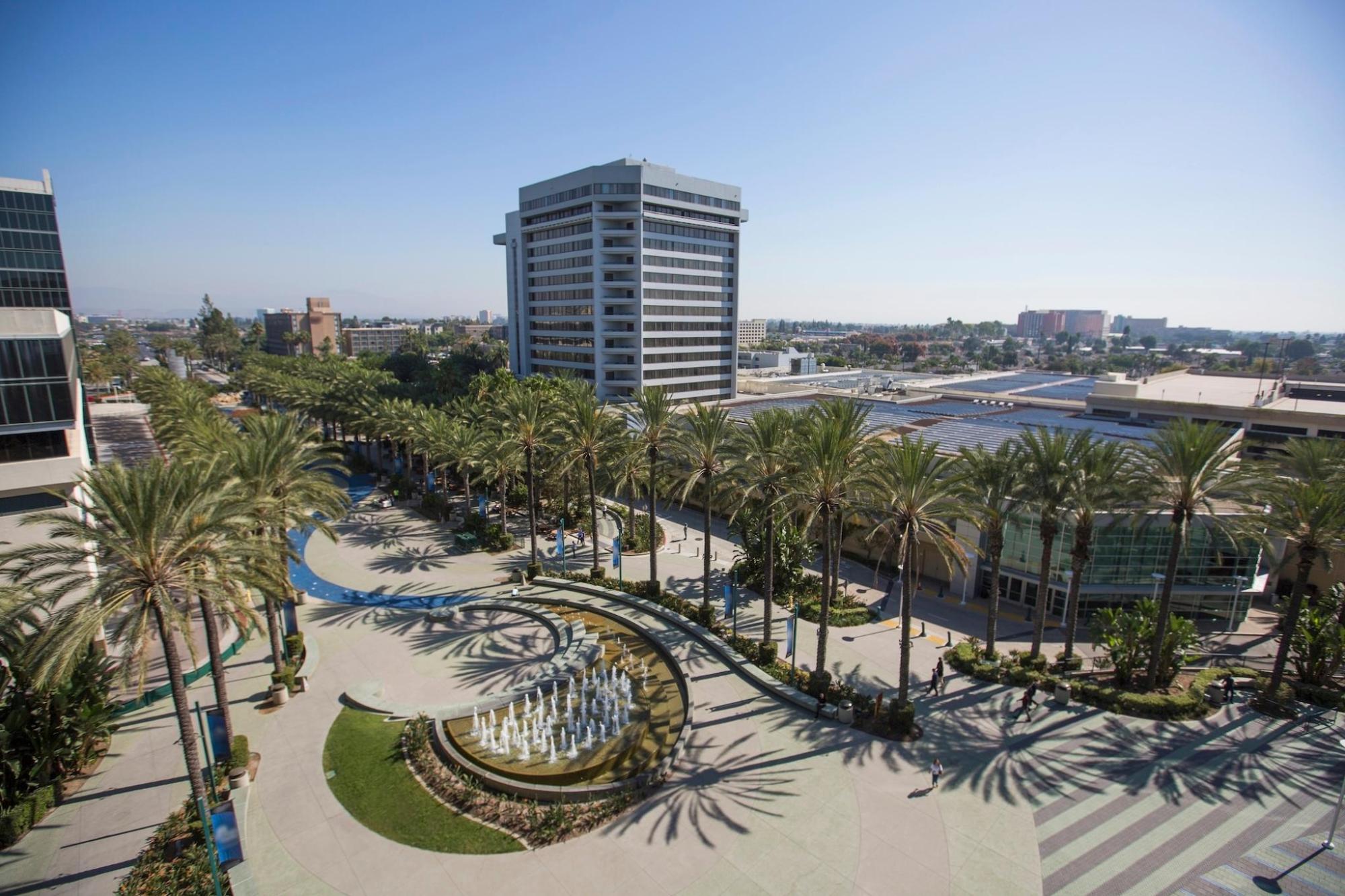 An aerial view of Anaheim with palm trees and tall buildings