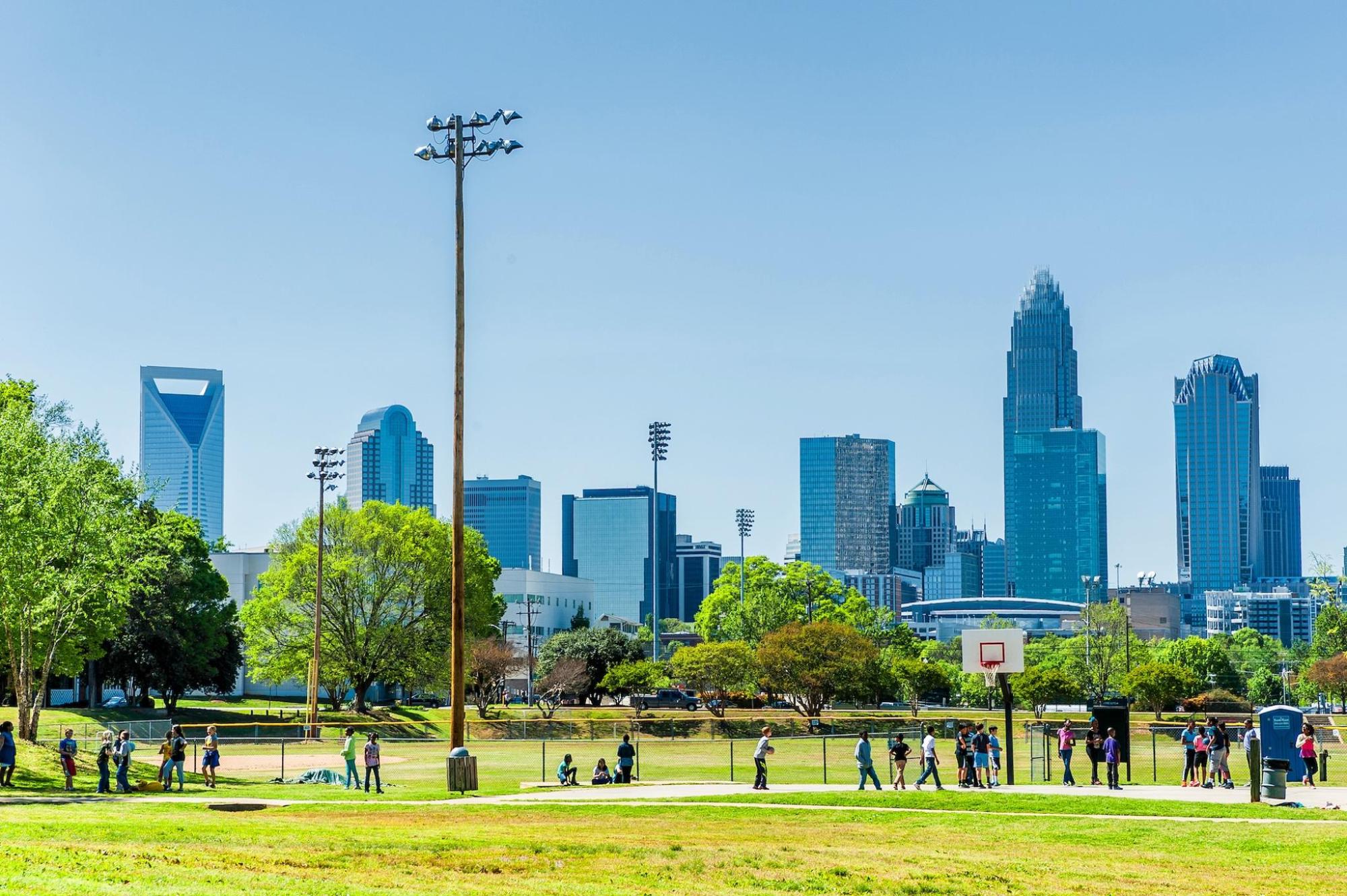 A large park in Charlotte with the cityscape behind