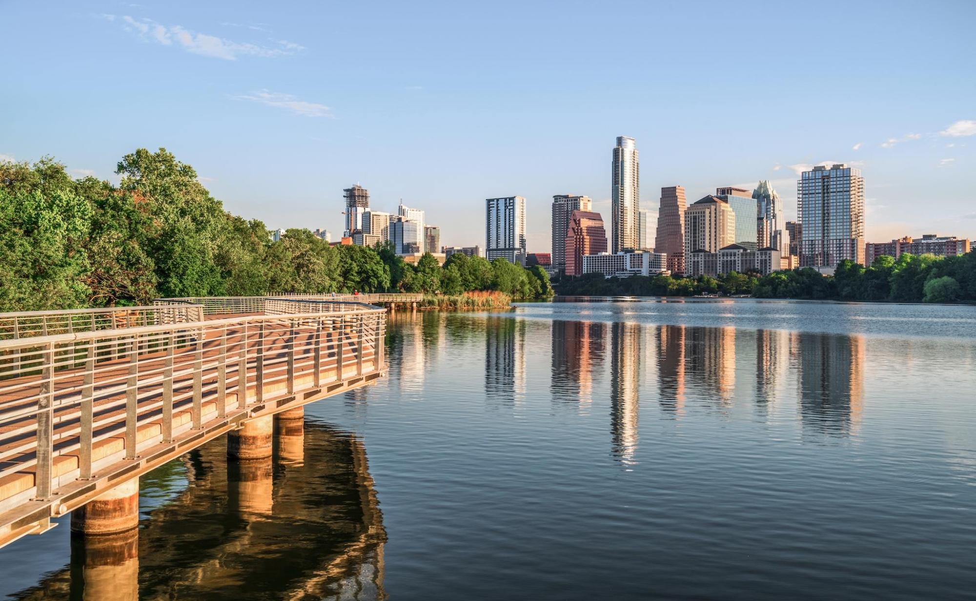 A scenic boardwalk in Austin with the cityscape in the back