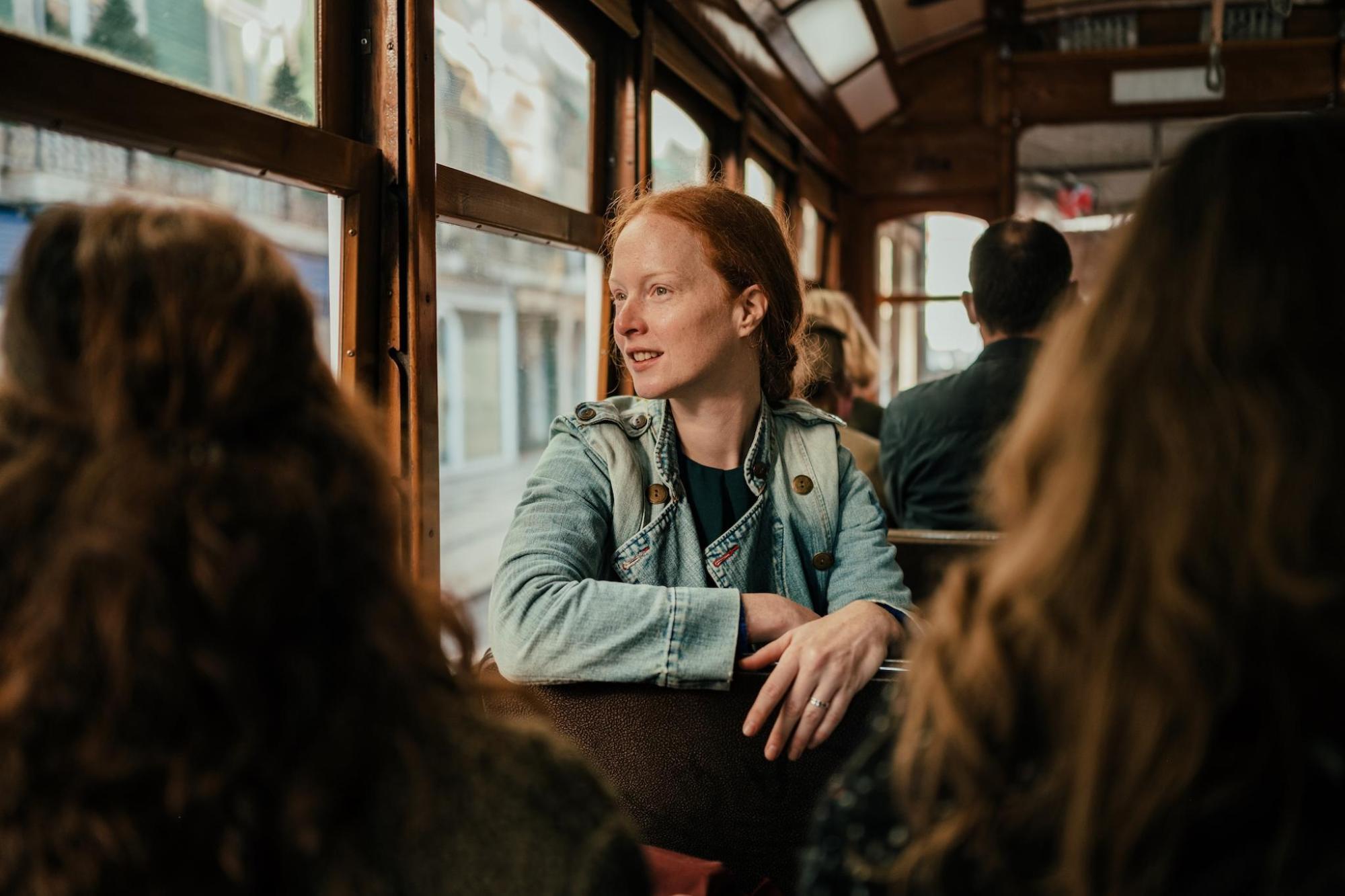 A woman and her friends enjoy a tram ride in Portugal