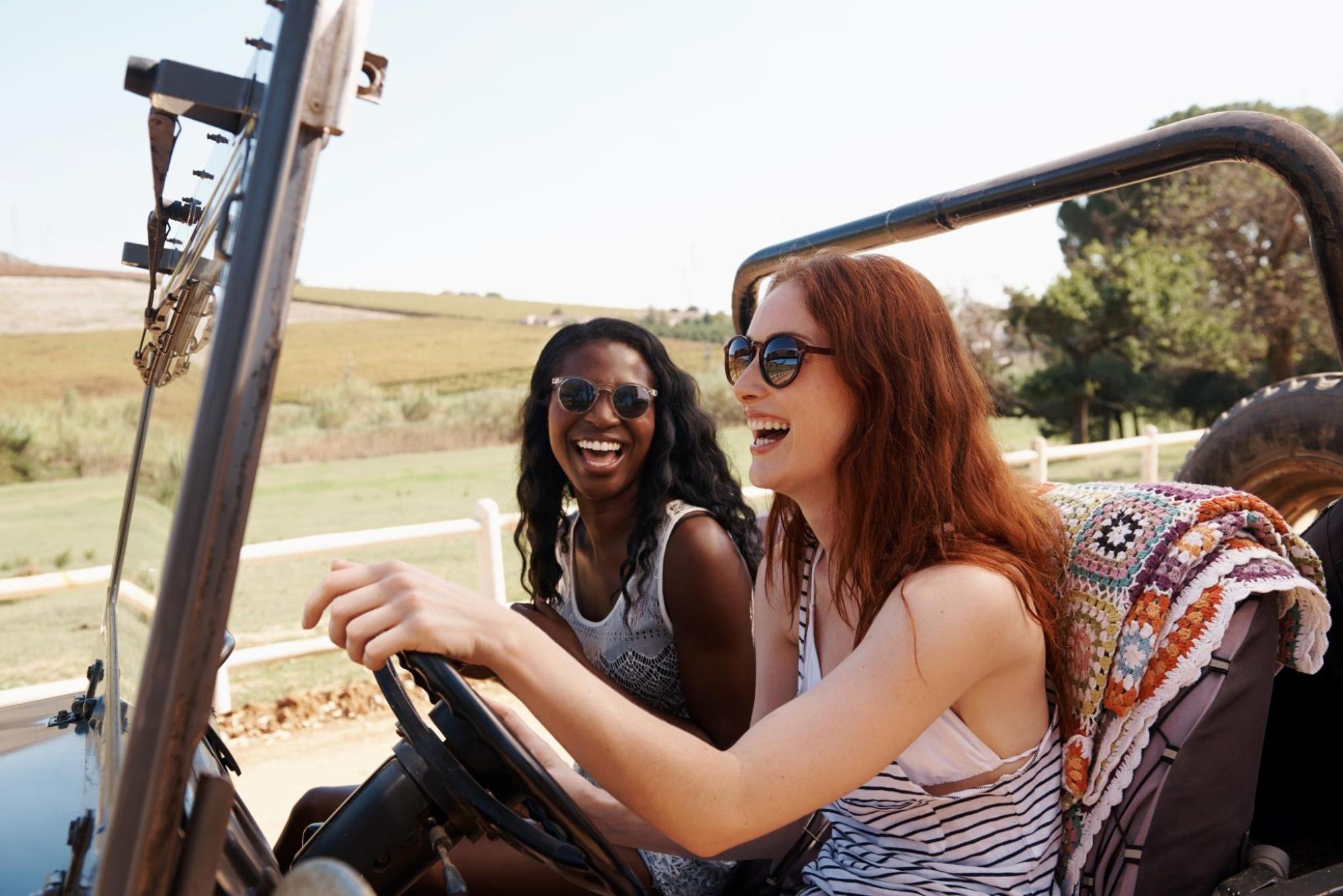 Two women in sunglasses enjoying a road trip in Australia.