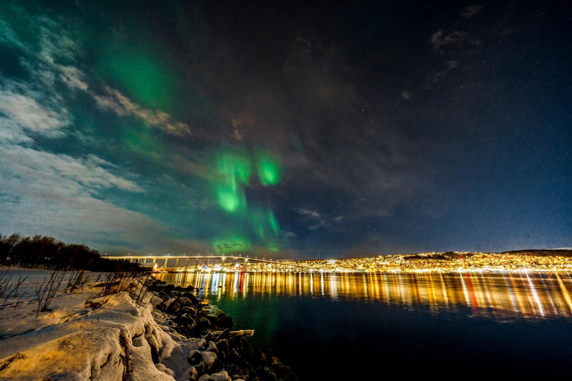 The northern lights glow green in Tromsø, Norway.