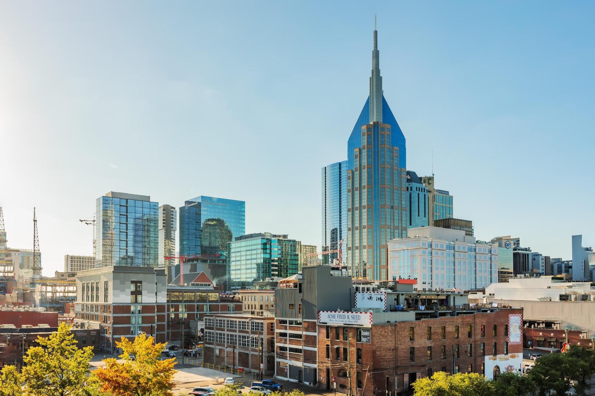 Nashville cityscape features tall buildings and a clear sky
